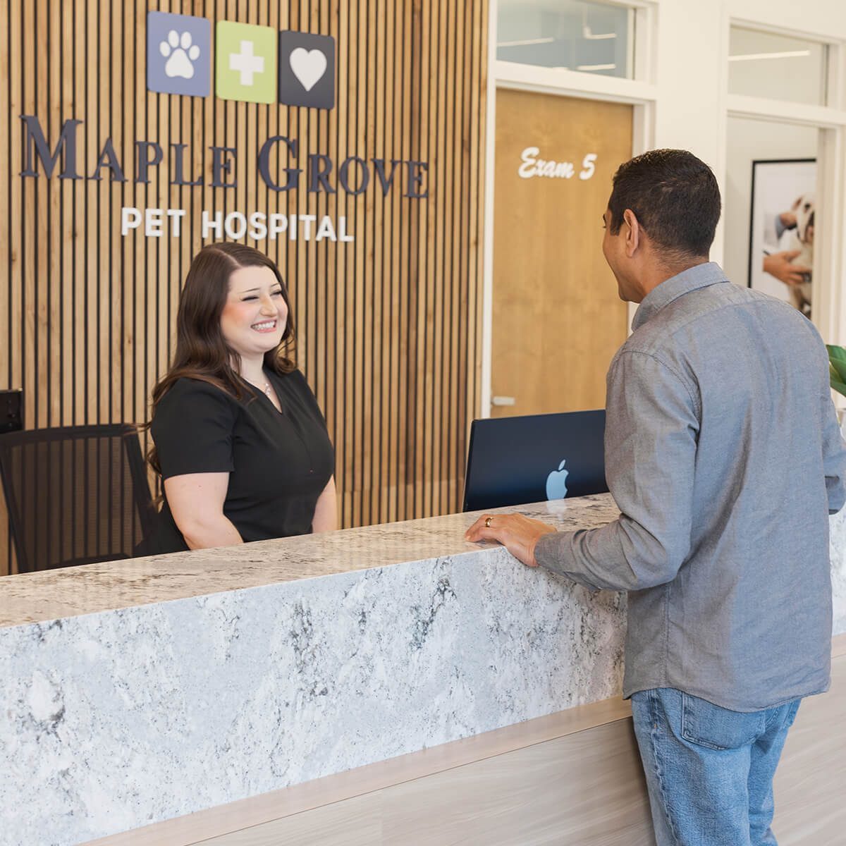smiling veterinary receptionist greeting client