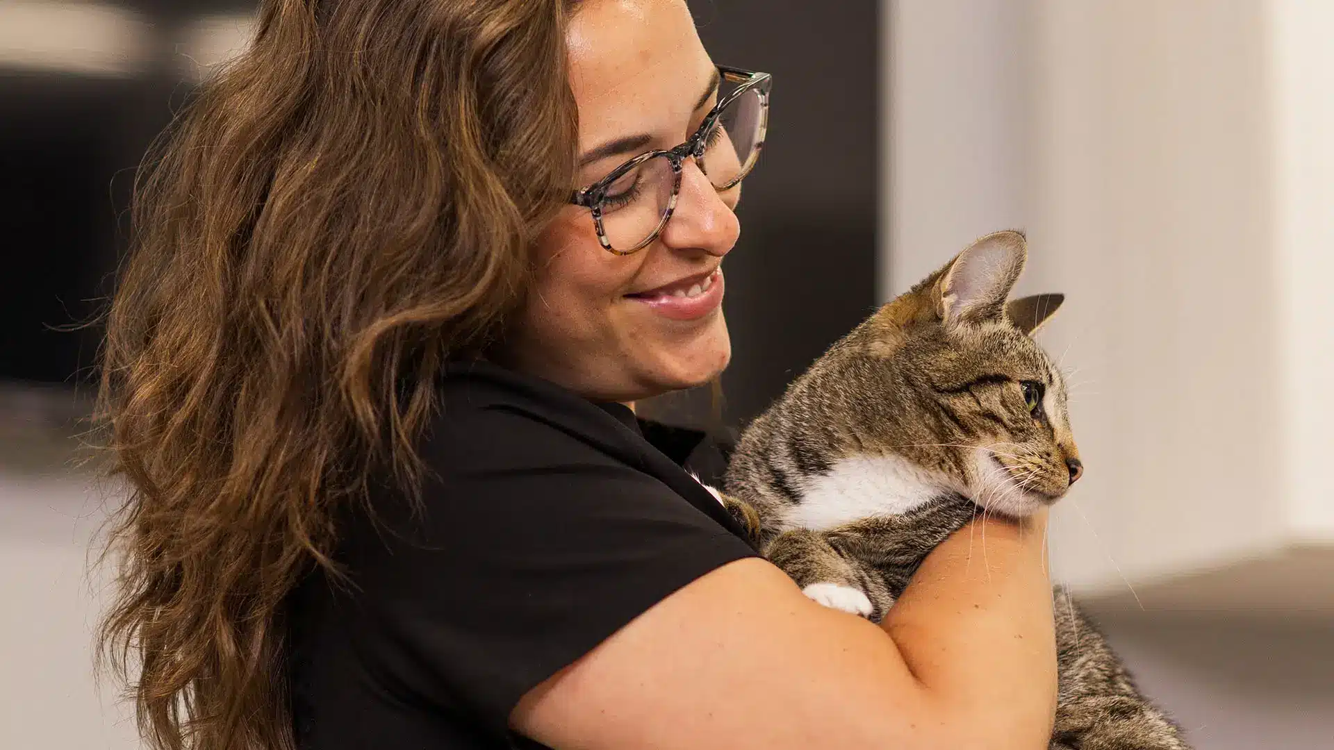 Young woman at a vet office holding a cat